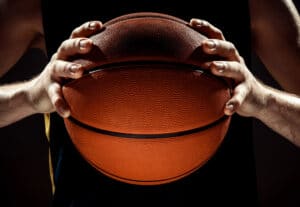 hands holding a basketball.
